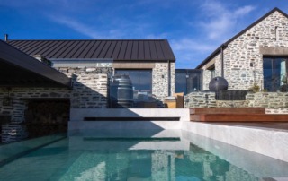 Completed landscape project in Bendemeer, Queenstown, featuring a stunning outdoor pool, surrounded by landscaped gardens and relaxing seating areas.