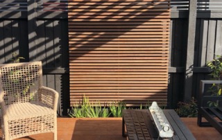 Completed small garden in Fendalton, Christchurch, featuring a Kwila timber pergola, wooden deck, and a striking feature panel, designed for a stylish outdoor living area.
